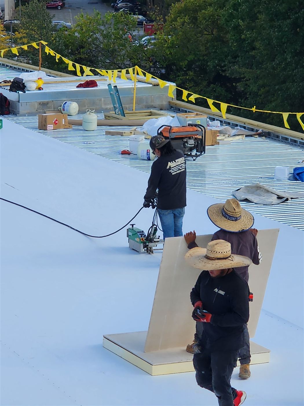 All Force crew installing roof insulation